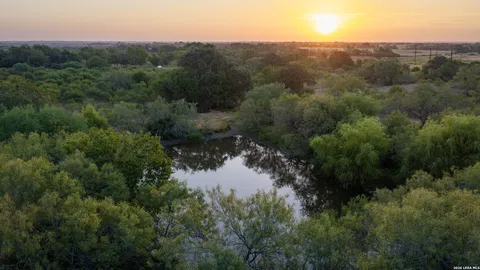 a view of a lake in middle of forest