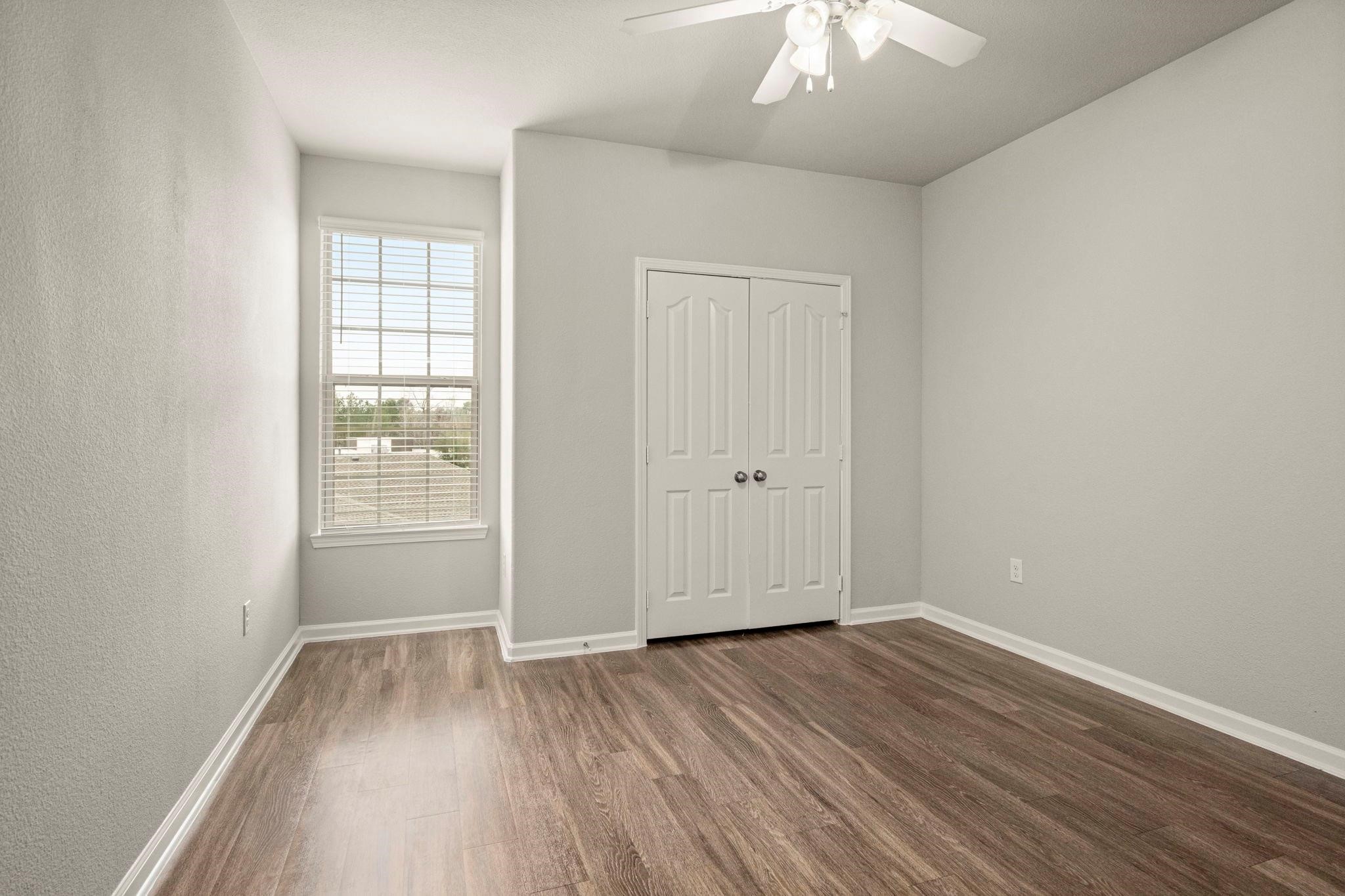 30685 Fm 2978 Road, Unit 4002 Magnolia, TX 77354 - Photo 11 of 16 an empty room with wooden floor and windows