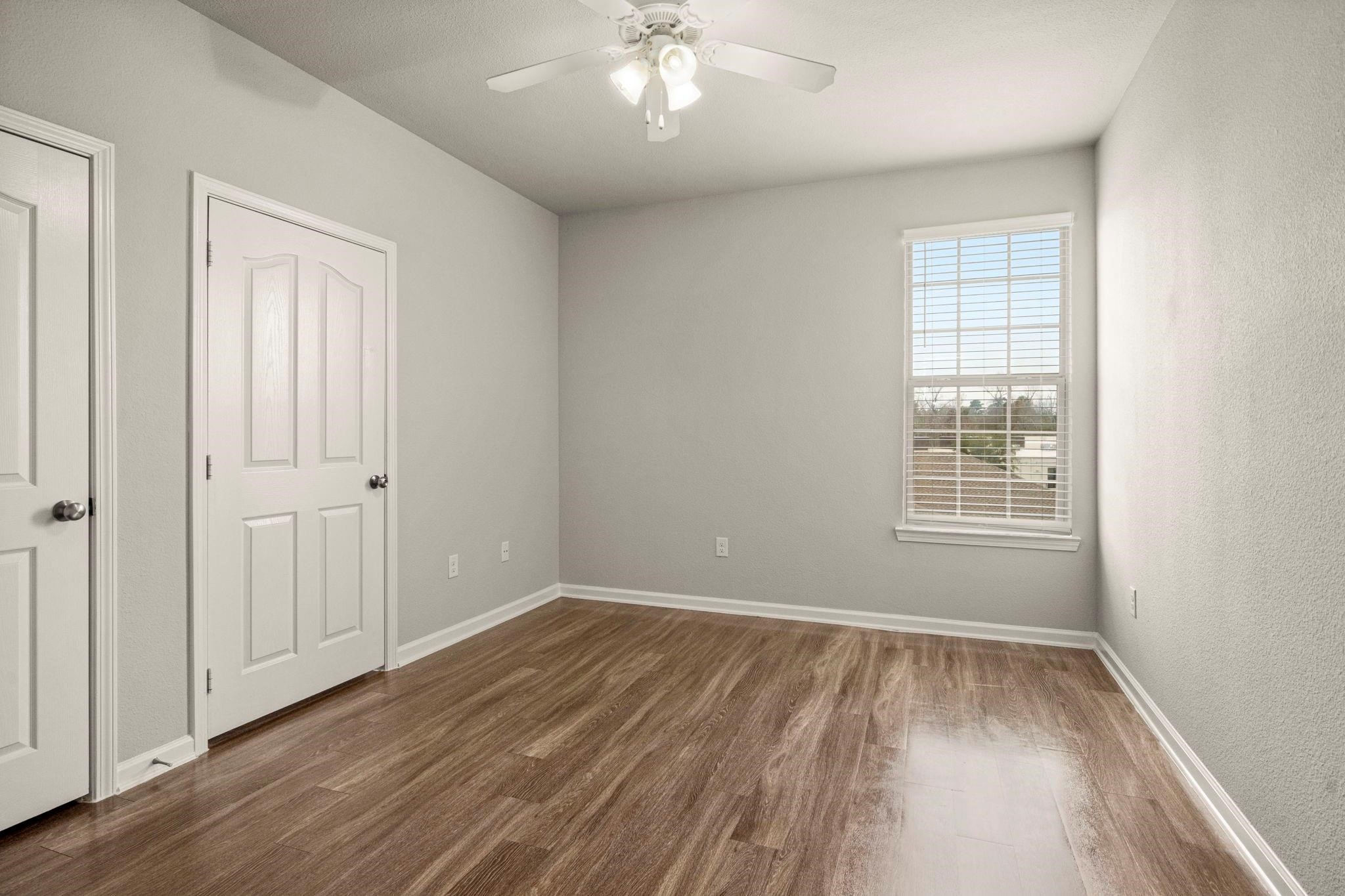 30685 Fm 2978 Road, Unit 4002 Magnolia, TX 77354 - Photo 12 of 16 a view of a room with wooden floor and windows