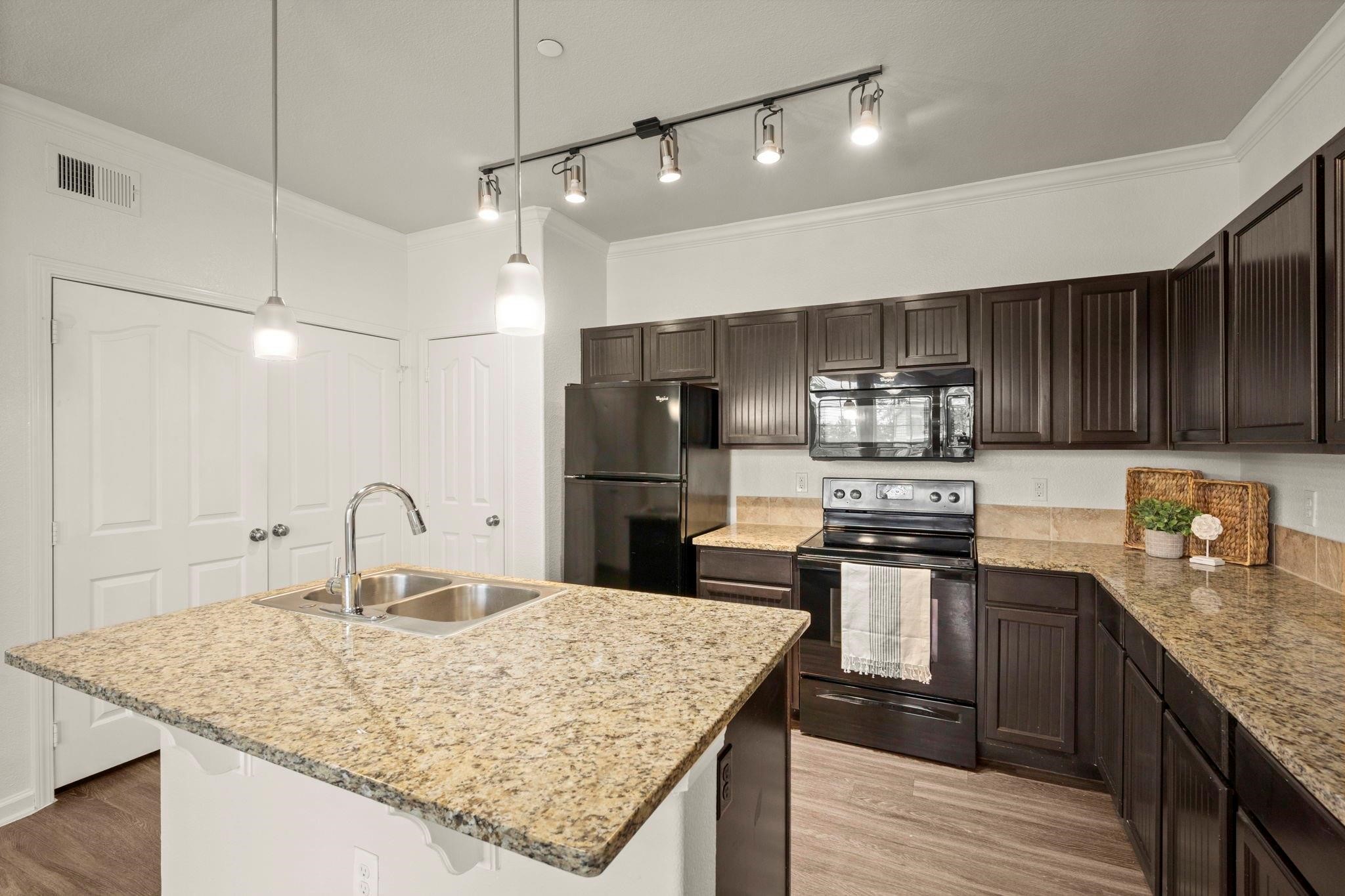 30685 Fm 2978 Road, Unit 4002 Magnolia, TX 77354 - Photo 2 of 16 a kitchen with kitchen island granite countertop a sink stove and refrigerator