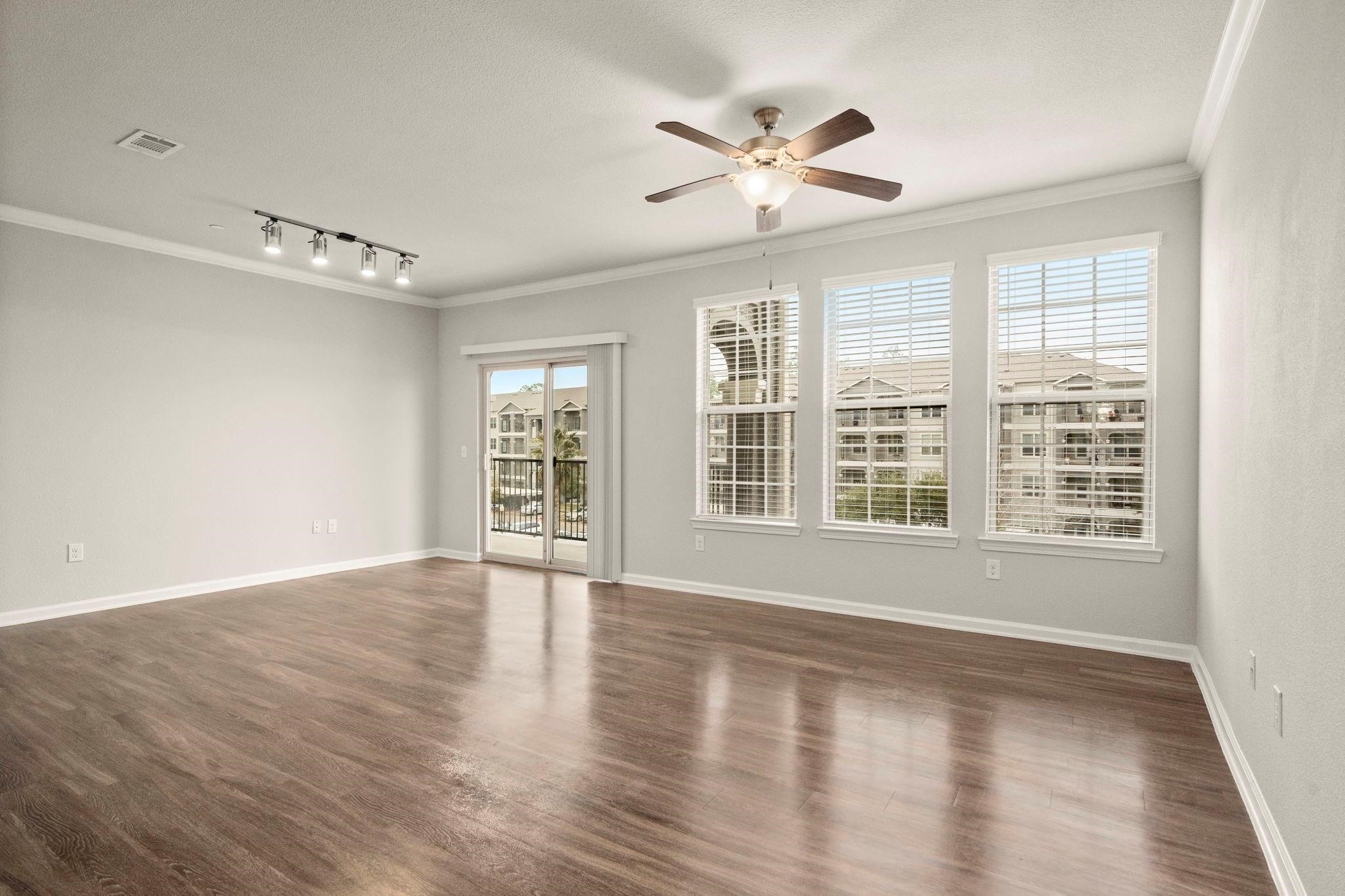 30685 Fm 2978 Road, Unit 4002 Magnolia, TX 77354 - Photo 3 of 16 a view of an empty room with a window and wooden floor