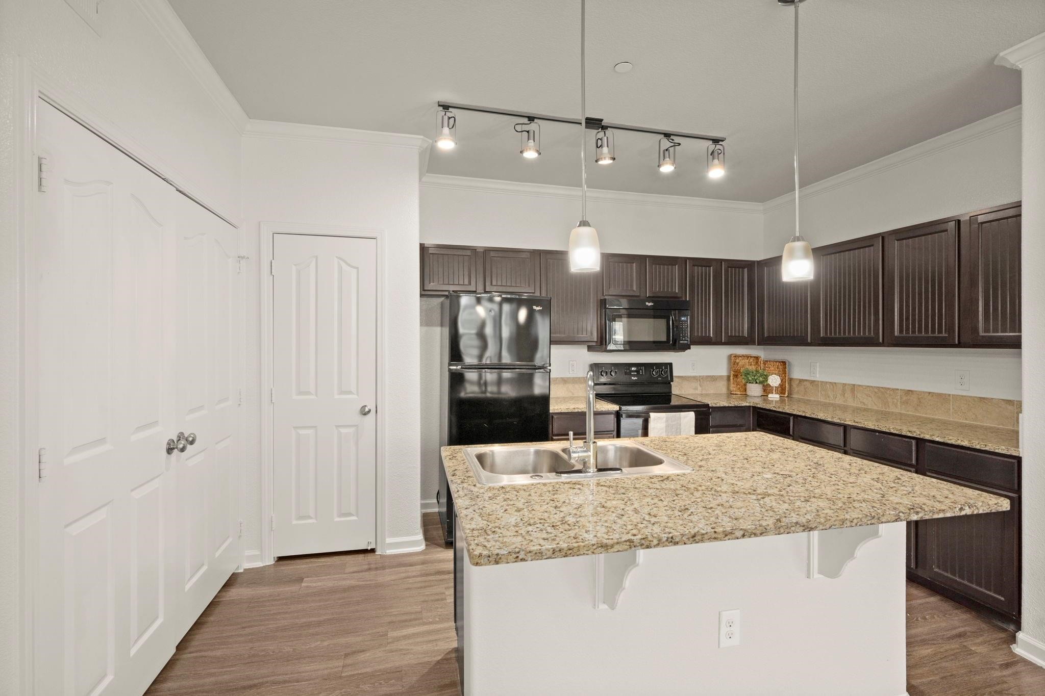 30685 Fm 2978 Road, Unit 4002 Magnolia, TX 77354 - Photo 4 of 16 a kitchen with kitchen island a large counter top space stainless steel appliances and cabinets