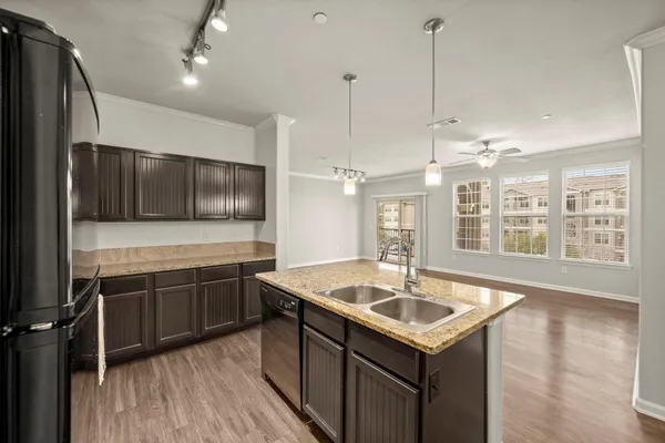 a kitchen with stainless steel appliances granite countertop a sink and a microwave