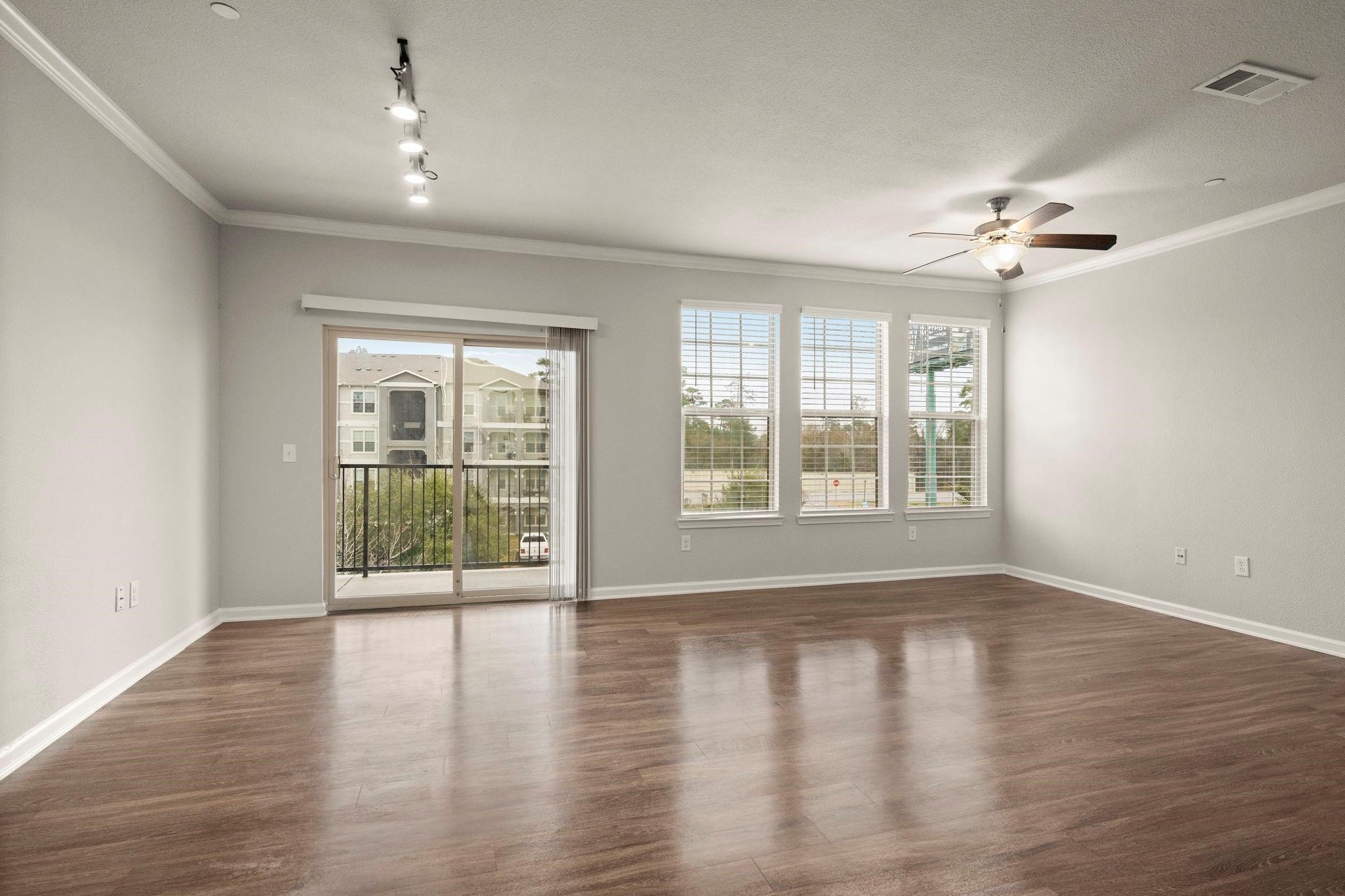 30685 Fm 2978 Road, Unit 4002 Magnolia, TX 77354 - Photo 7 of 16 a view of an empty room with wooden floor and a window