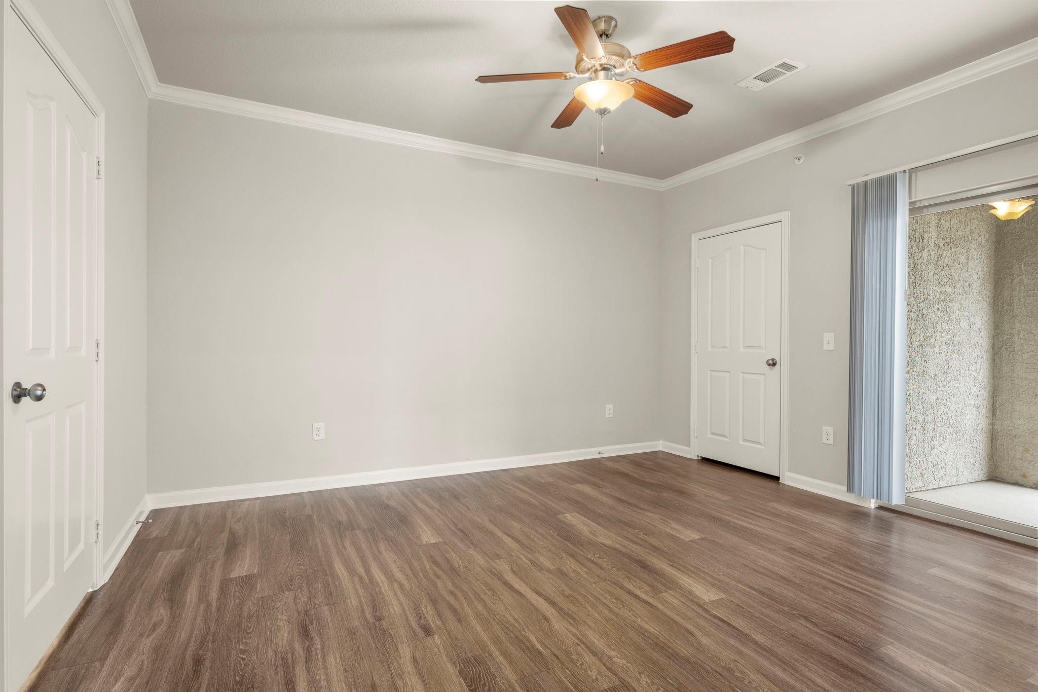 30685 Fm 2978 Road, Unit 4002 Magnolia, TX 77354 - Photo 10 of 16 an empty room with wooden floor a ceiling fan and closet