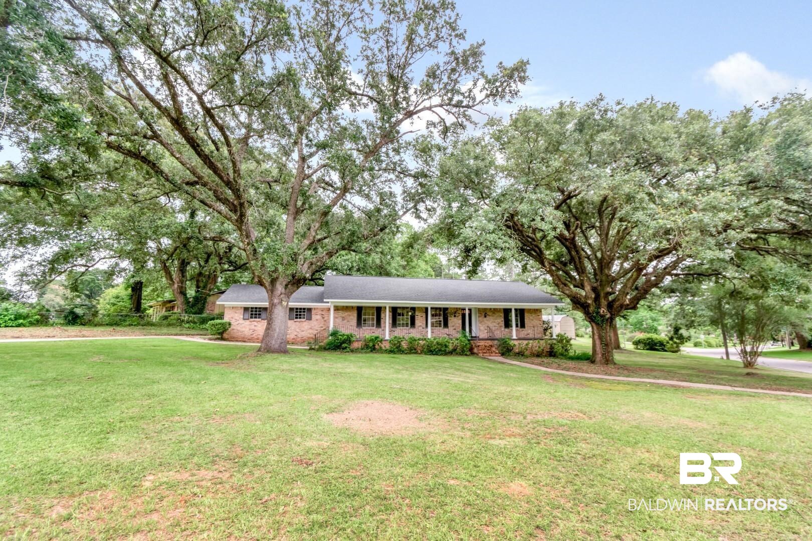 5217 Perin Road Mobile, AL 36693 - Photo 44 of 45 Traditional brick-front ranch home with a covered front porch featuring white columns and a dark shingle roof