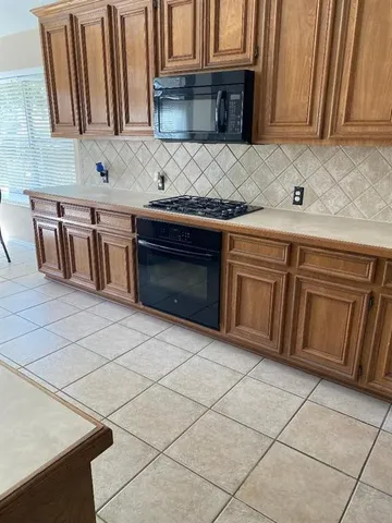 a kitchen with granite countertop a sink and a stove