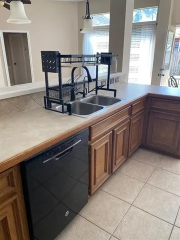 a kitchen with stainless steel appliances granite countertop a sink and a white cabinets