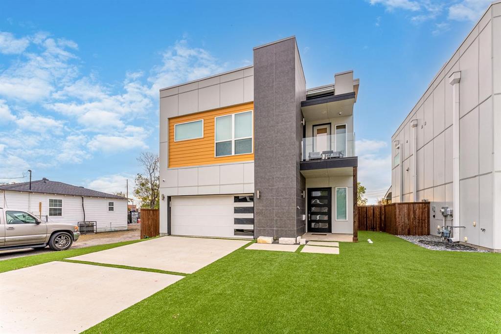 4013 Ivanhoe Lane Dallas, TX 75212 - Photo 1 of 38 View of front facade with a balcony, a garage, and a front lawn