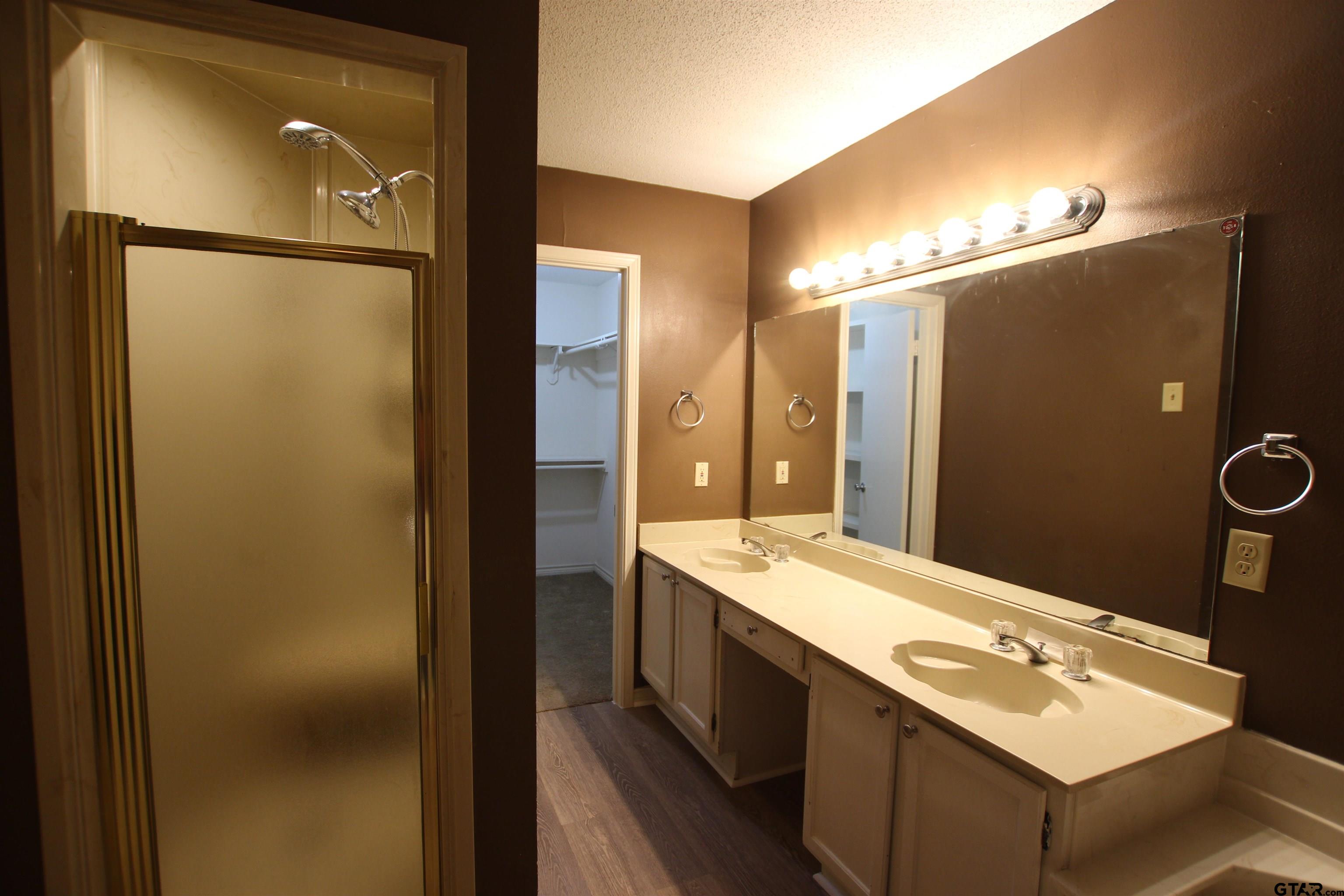 5875 Creekside Circle Tyler, TX 75703 - Photo 22 of 32 a bathroom with a double vanity sink mirror and shower