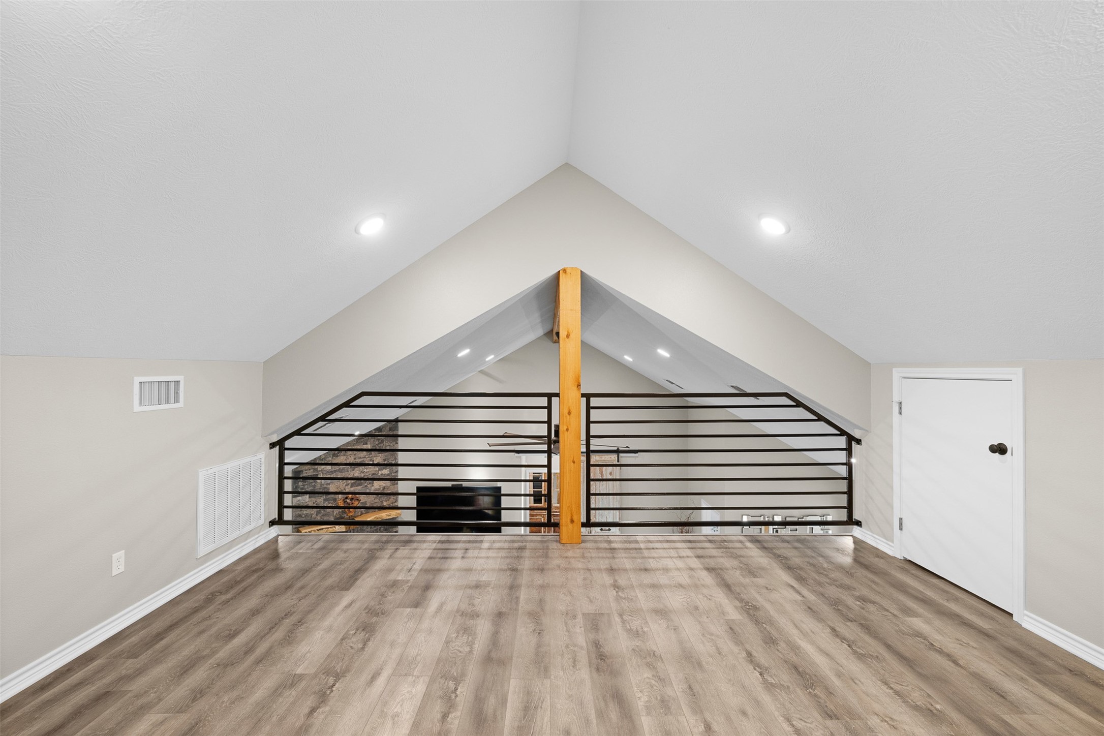 7541 Halamicek Loop Fayetteville, TX 78940 - Photo 23 of 29 a view of a room with wooden stairs and a ceiling fan