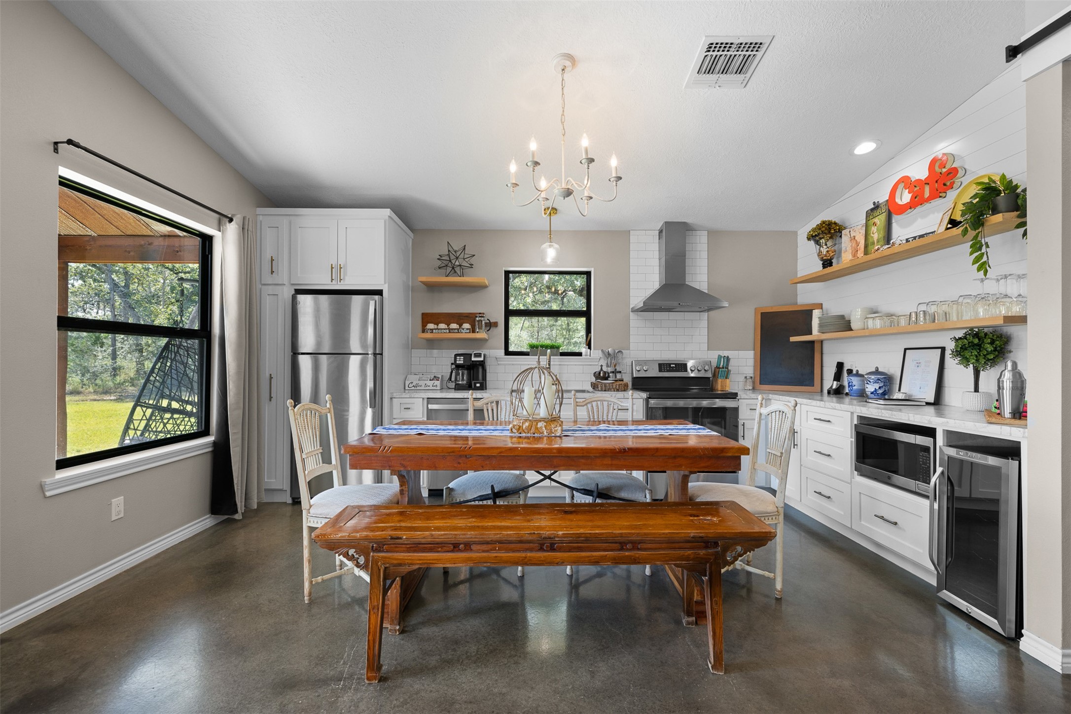 7541 Halamicek Loop Fayetteville, TX 78940 - Photo 6 of 29 a large kitchen with a table chairs refrigerator and cabinets
