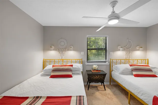 a bedroom with a bed and a lamp on dresser