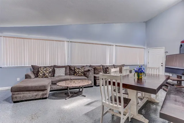 a large kitchen with kitchen island a large counter space a sink stainless steel appliances and cabinets