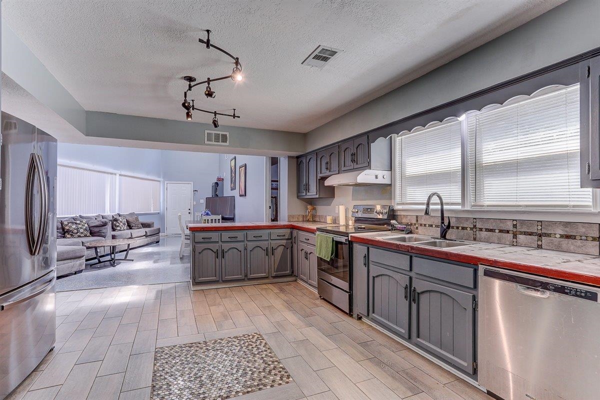 3700 Lakeview Road Memphis, TN 38116 - Photo 40 of 40 a large kitchen with kitchen island a large counter space a sink stainless steel appliances and cabinets