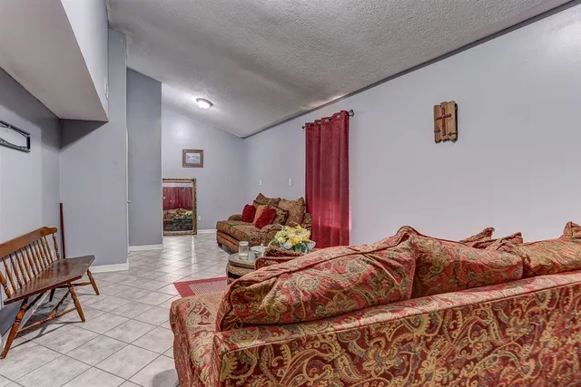 a bed room with a bed and a chair