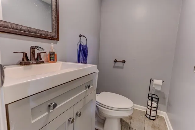 a bathroom with a sink a toilet and a mirror