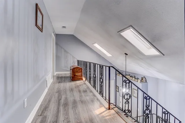 a view of entryway and hall with wooden floor