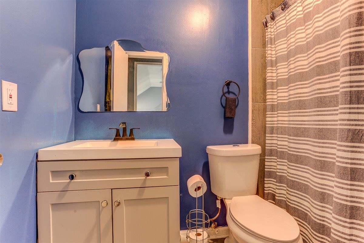 3700 Lakeview Road Memphis, TN 38116 - Photo 32 of 40 a bathroom with a toilet sink vanity and mirror