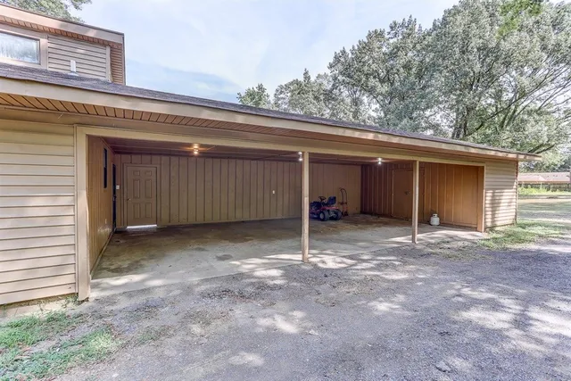 a view of a house with a garage and yard
