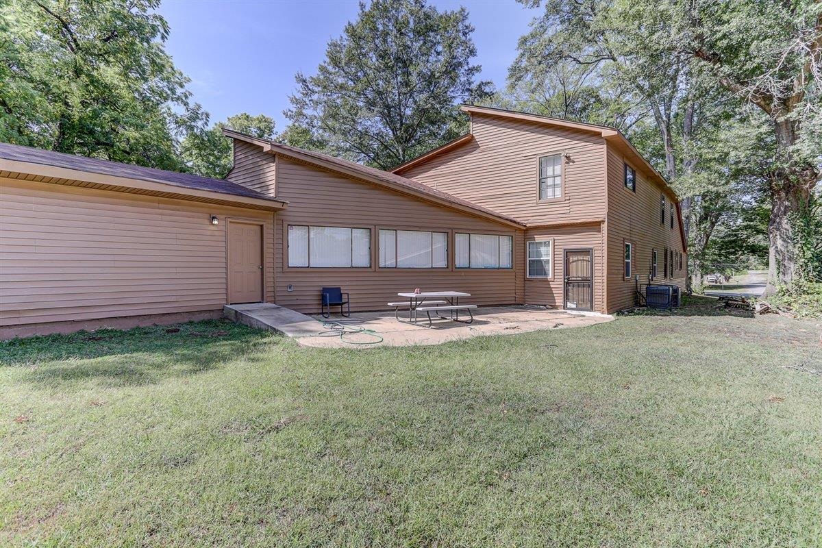 3700 Lakeview Road Memphis, TN 38116 - Photo 9 of 40 a view of a backyard with table and chairs and large tree