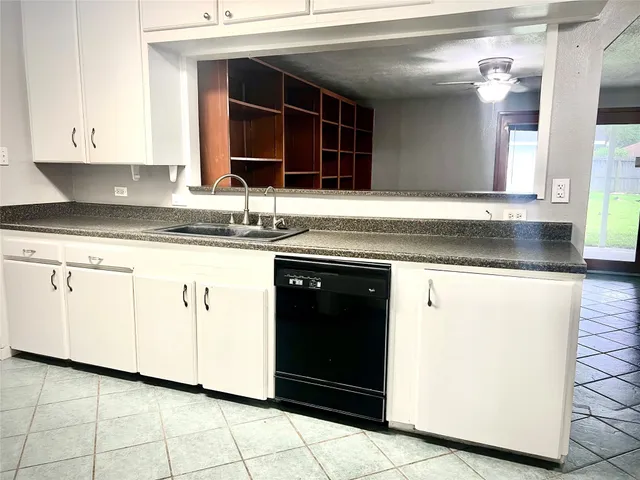 a kitchen with granite countertop a sink and a stove