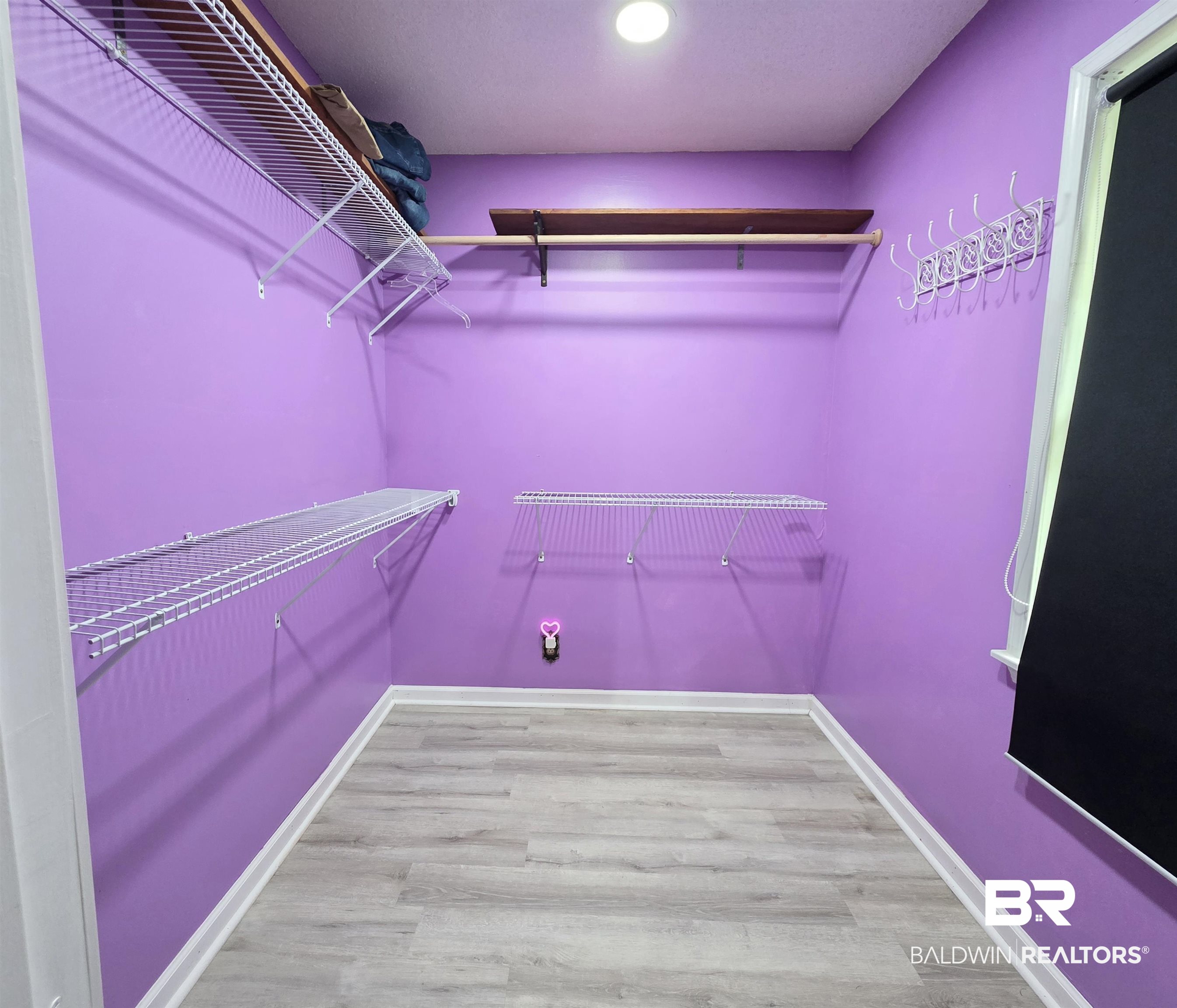 558 Stanton Road Atmore, AL 36502 - Photo 10 of 29 Spacious closet featuring multiple wire shelving units, a wood-finish hanging rod, and light wood-finish flooring