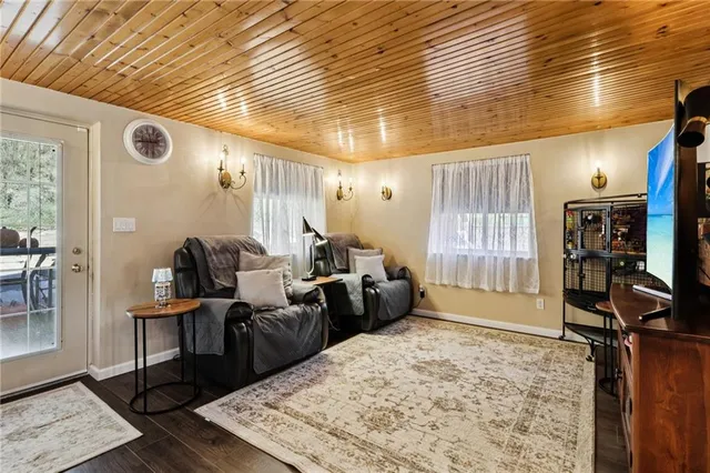 a living room with furniture a window and gym equipment