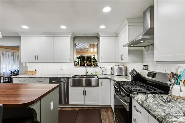 a kitchen with a stove sink and cabinets