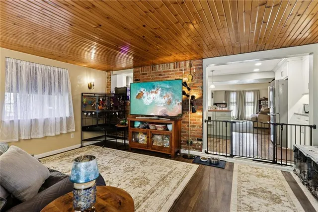 a living room with furniture pool table and a flat screen tv
