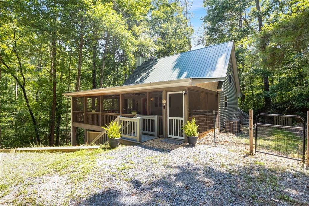 129 Jump Street Talking Rock, GA 30175 - Photo 1 of 45 a view of a house with a yard and a large tree