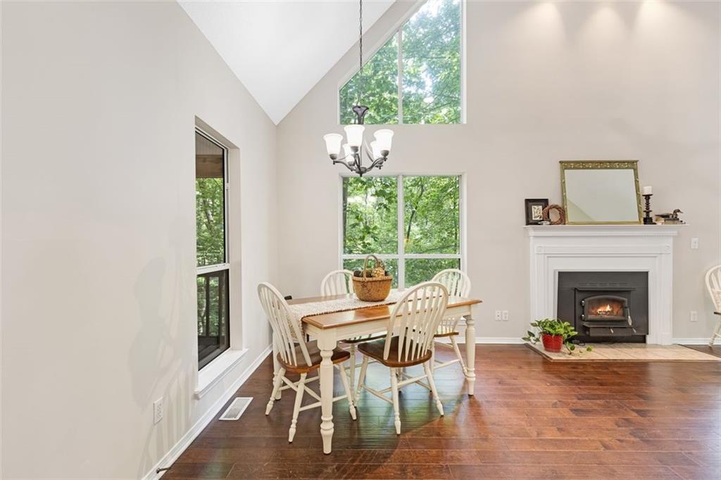 129 Jump Street Talking Rock, GA 30175 - Photo 12 of 45 a dining room with furniture a fireplace and wooden floor