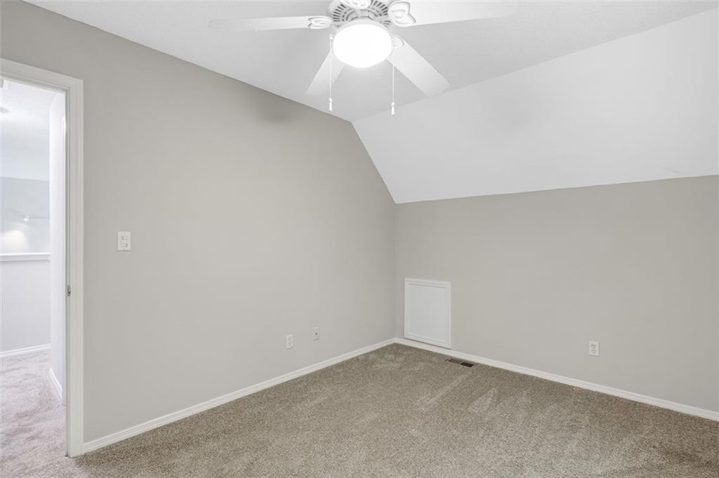 129 Jump Street Talking Rock, GA 30175 - Photo 31 of 45 an empty room with a chandelier fan and windows