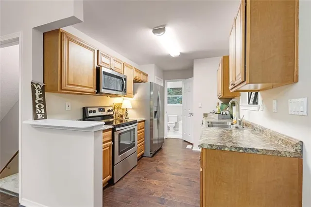 a kitchen with stainless steel appliances granite countertop a sink stove and refrigerator