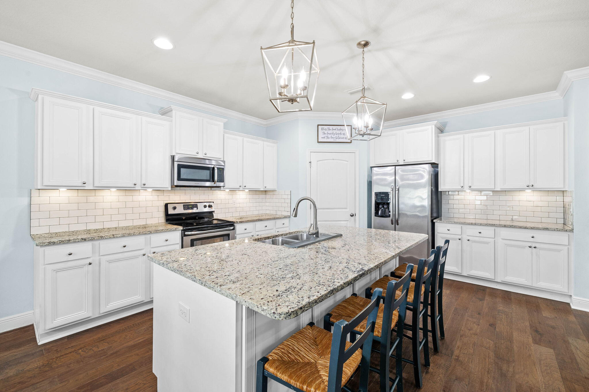 672 Alderberry Road Santa Rosa Beach, FL 32459 - Photo 9 of 24 a kitchen with stainless steel appliances granite countertop a kitchen island a stove a table and chairs in it