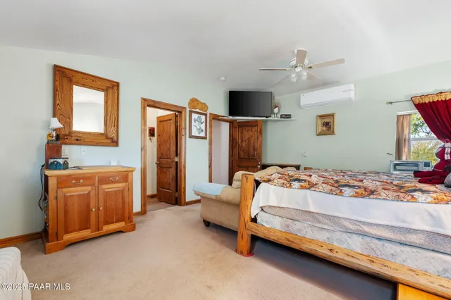 a bedroom with bed and cabinets