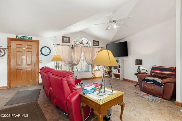 a living room with furniture a rug and a window