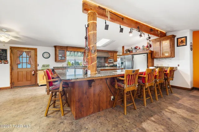 a dining room with furniture and a kitchen