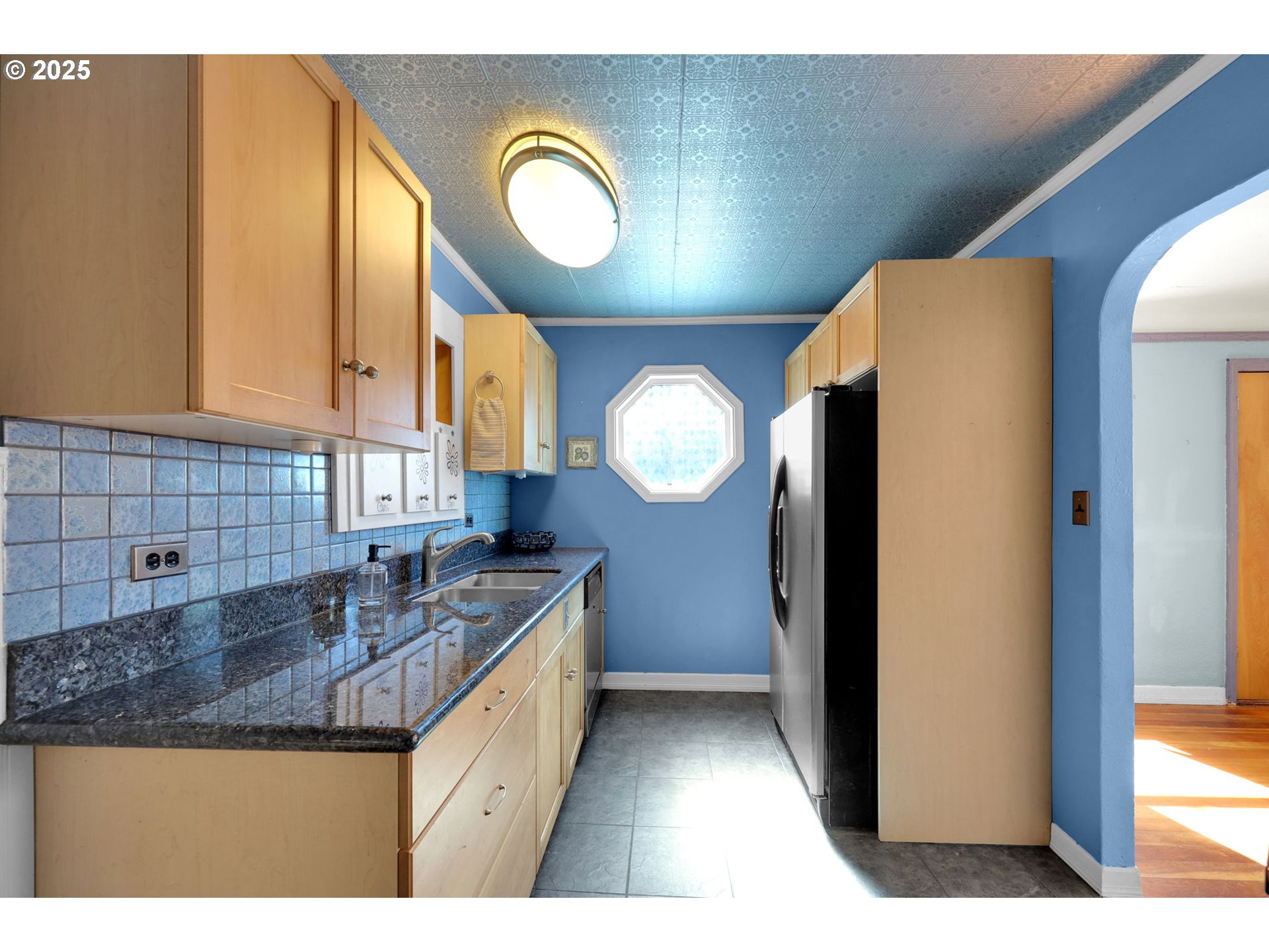 183 South 50th Place Springfield, OR 97478 - Photo 6 of 29 a kitchen with granite countertop a sink a stove and a wooden floors