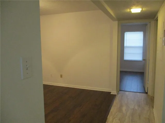 an empty room with wooden floor and closet