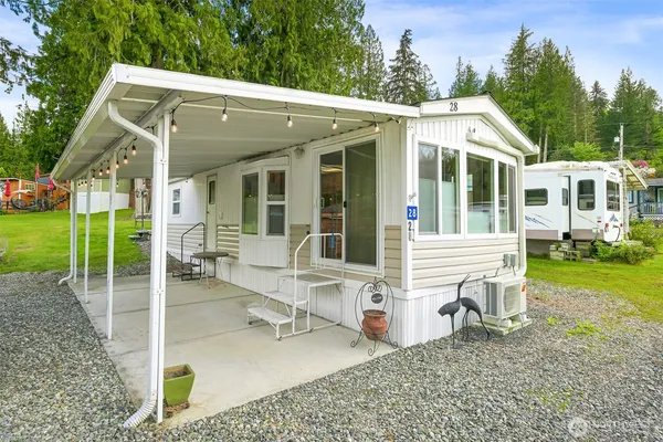 a view of a house with backyard porch and sitting area