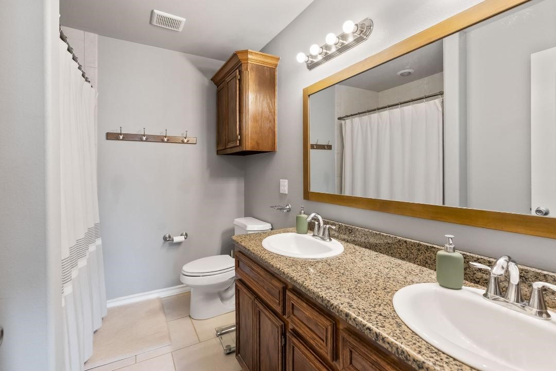 4328 Bratton Road Corpus Christi, TX 78413 - Photo 13 of 24 a bathroom with a granite countertop sink mirror and toilet