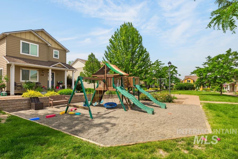 1337 Bristol Road Moscow, ID 83843 - Photo 24 of 28 Community play structure featuring multiple slides, swings, and a climbing area on a sand base