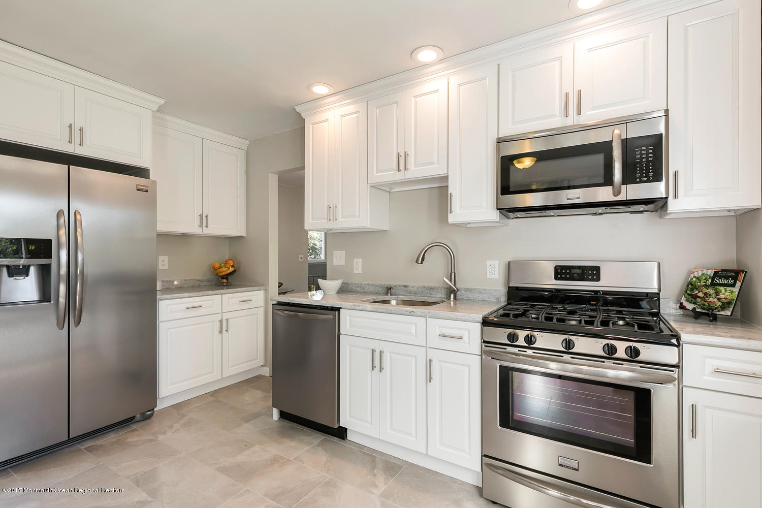 524 E Road Middletown, NJ 07718 - Photo 5 of 40 a kitchen with stainless steel appliances granite countertop white cabinets a stove a sink and a microwave