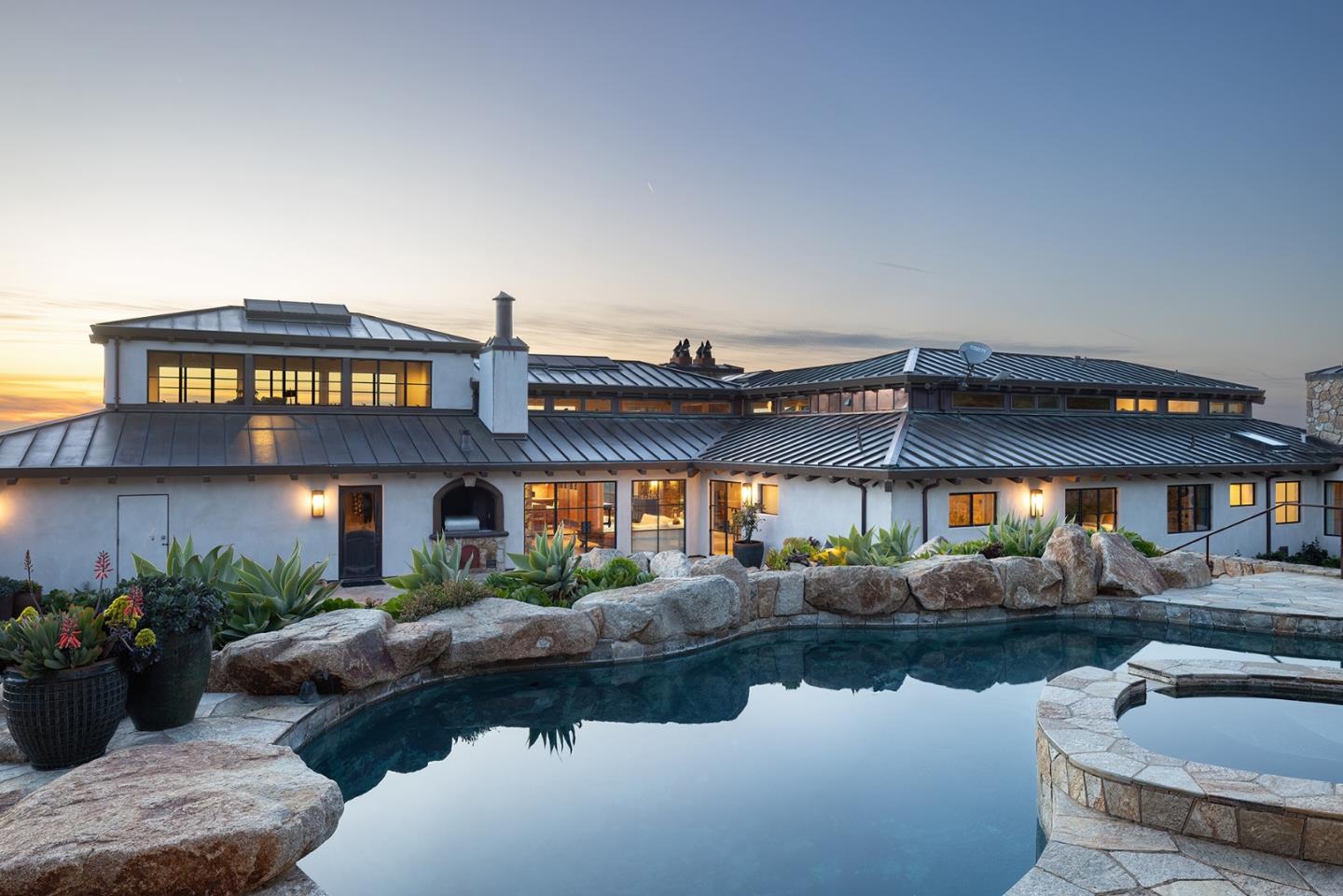31453 Highway 1 Carmel, CA 93923 - Photo 20 of 58 a large building with a swimming pool and chairs