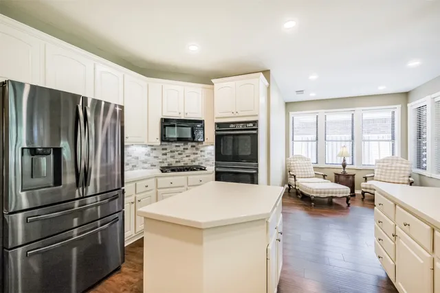 a kitchen with a refrigerator stove and microwave