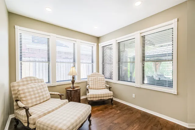 a living room with furniture and floor to ceiling windows