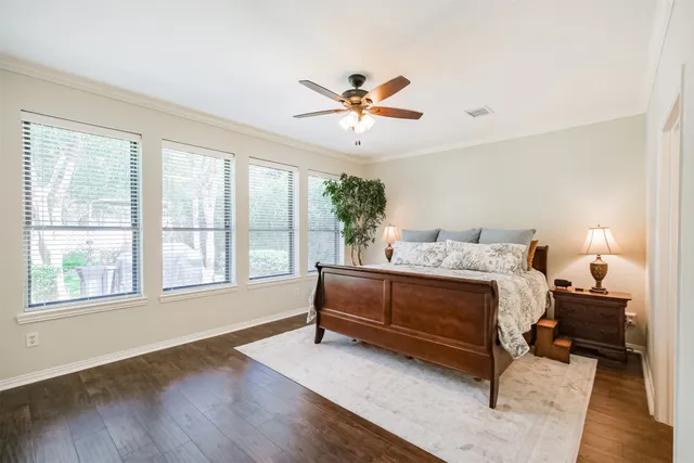 a spacious bedroom with a bed and a window