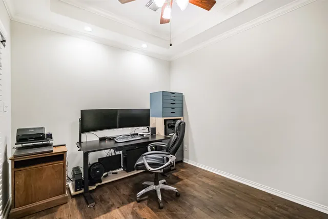 a view of a workspace with furniture and a window