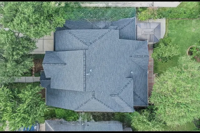 an aerial view of a house with a yard